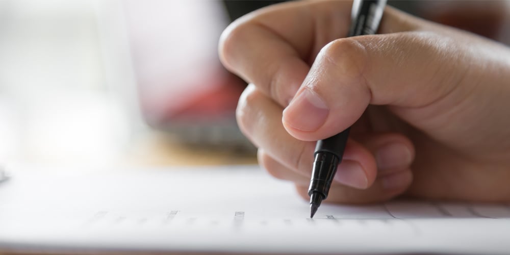 hand-writing-paper-with-pen